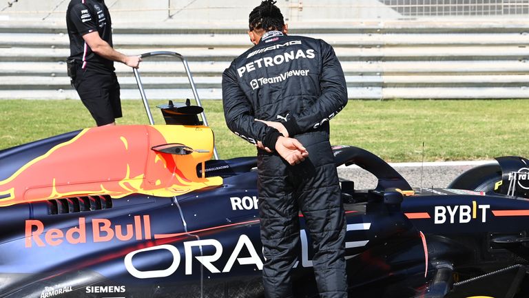 BAHRAIN INTERNATIONAL CIRCUIT, BAHRAIN - FEBRUARY 23: Sir Lewis Hamilton, Mercedes-AMG, Red Bull Racing RB19 Sir Lewis Hamilton, Mercedes-AMG, inspects the Red Bull Racing RB19 during the Bahrain February Testing at Bahrain International Circuit on Thursday February 23, 2023 in Sakhir, Bahrain. (Photo by Mark Sutton / Sutton Images)