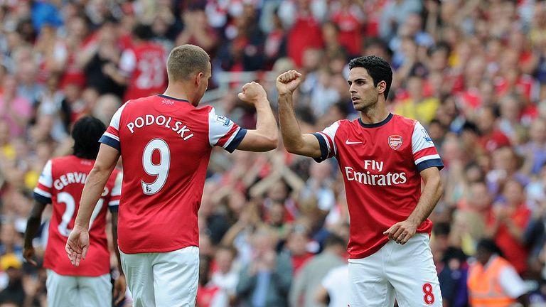 Lukas Podolski and Mikel Arteta of Arsenal during the Barclays Premier League match between Arsenal and Southampton at Emirates Stadium on September 15, 2012 in London, England. (Photo by David Price/Arsenal FC via Getty Images)