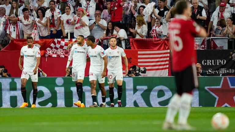 Sevilla's Youssef En-Nesyri celebrates with teammates after scoring his side's opening goal during the Europa League quarter finals second leg soccer match between Sevilla and Manchester United, at the Ramon Sanchez Pizjuan stadium in Seville, Spain, Thursday, April 20, 2023. (AP Photo/Jose Breton)