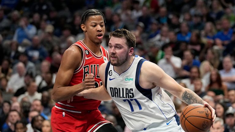 Dallas Mavericks guard Luka Doncic (77) works to the basket as Chicago Bulls forward Dalen Terry, left, defends in the first half of an NBA basketball game Friday, April 7, 2023, in Dallas. 