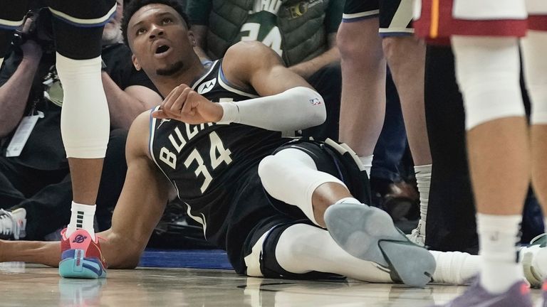 Milwaukee Bucks' Giannis Antetokounmpo lays on the ground after injuring his lower back.