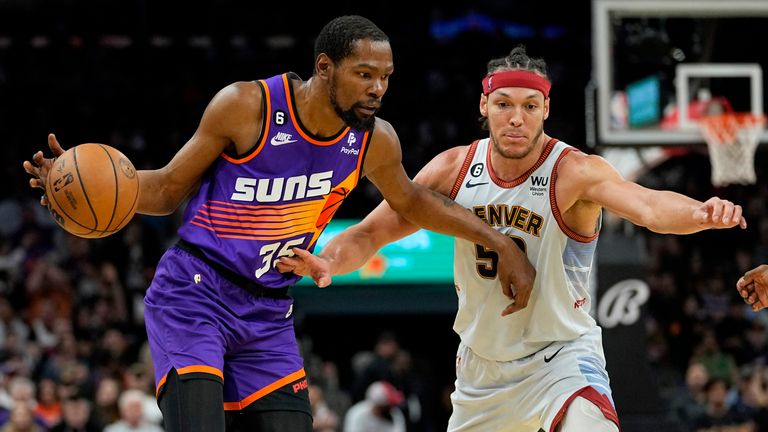 Phoenix Suns forward Kevin Durant (35) drives as Denver Nuggets forward Aaron Gordon (50) defends during the second half of an NBA basketball game, Friday, March 31, 2023, in Phoenix. (AP Photo/Matt York)


