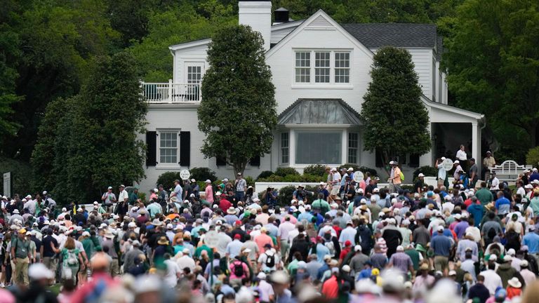 Patrons leave the course during a weather delay in the second round of The Masters