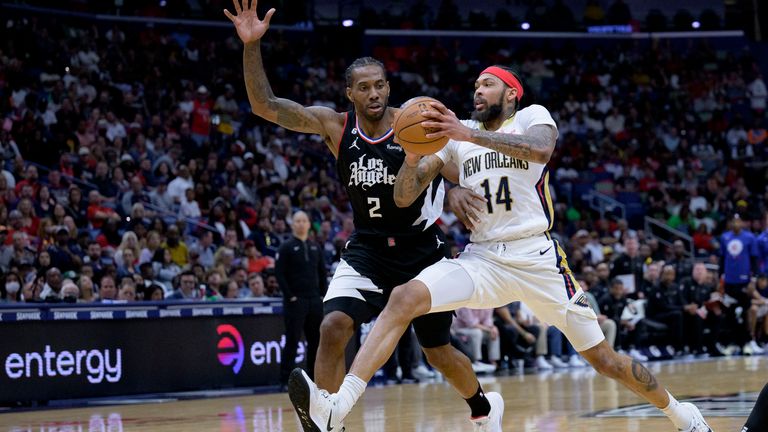 New Orleans Pelicans forward Brandon Ingram (14) drives around Los Angeles Clippers forward Kawhi Leonard (2) during the second half of an NBA basketball game in New Orleans, Saturday, April 1, 2023. (AP Photo/Matthew Hinton)
