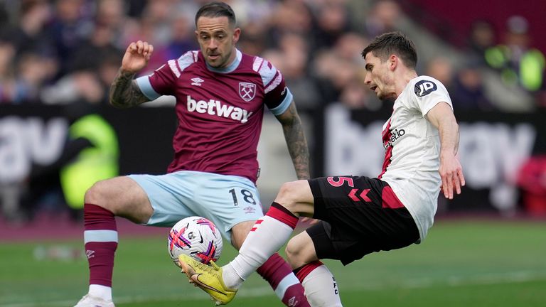 Danny Ings and Romain Perraud challenge for the ball
