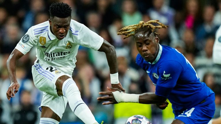 Real Madrid's Vinicius Junior, left, shoots the ball next to Chelsea's Trevoh Chalobah during the Champions League quarter final first leg soccer match between Real Madrid and Chelsea at Santiago Bernabeu stadium in Madrid, Wednesday, April 12, 2023. Real Madrid won 2-0. (AP Photo/Jose Breton)