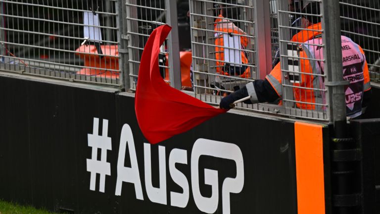 MELBOURNE GRAND PRIX CIRCUIT, AUSTRALIA - APRIL 01: A marshal waves a red flag during the Australian GP at Melbourne Grand Prix Circuit on Saturday April 01, 2023 in Melbourne, Australia. (Photo by Simon Galloway / LAT Images)