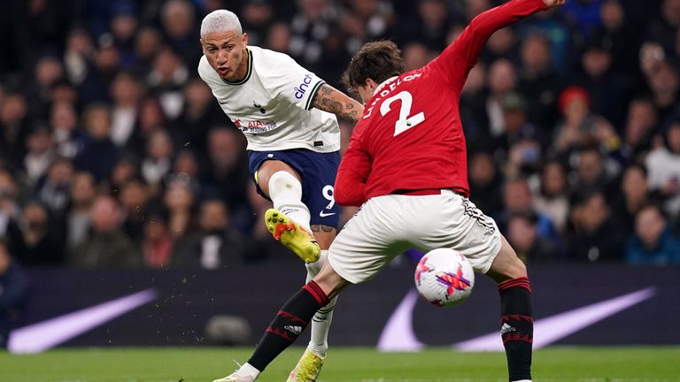 Richarlison shoots at goal under pressure from Victor Lindelof