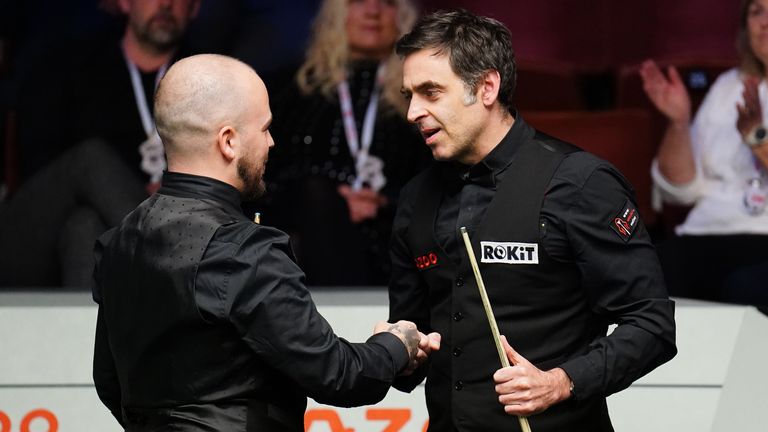 Ronnie O'Sullivan shakes hands with opponent Luca Brecel after losing in the quarter-final of the World Snooker Championship