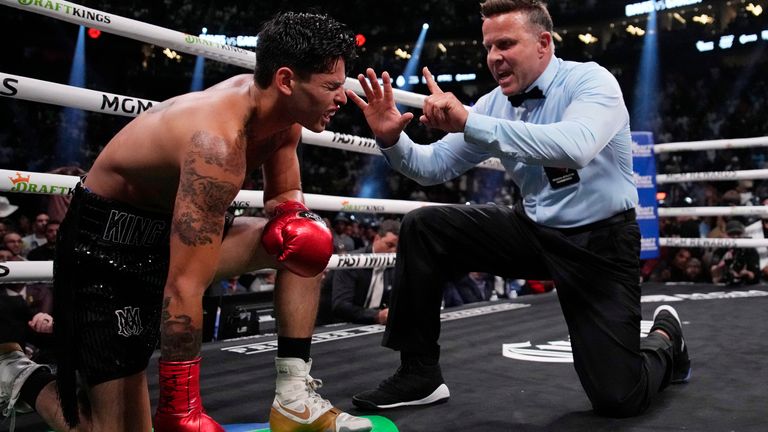 Referee Thomas Taylor counts out Ryan Garcia, who was sent to one knee by a brutal Davis body shot 