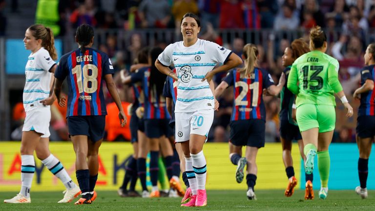 Chelsea's Samantha Kerr looks dejected as Barcelona players celebrate at reaching the final at full time