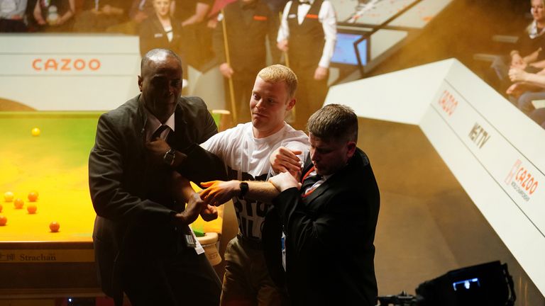 Cazoo World Snooker Championship 2023 - Day 3 - The Crucible
A Just Stop Oil protester is removed after jumping on the table and throwing orange powder during the match between Robert Milkins against Joe Perry during day three of the Cazoo World Snooker Championship at the Crucible Theatre, Sheffield. Picture date: Monday April 17, 2023.