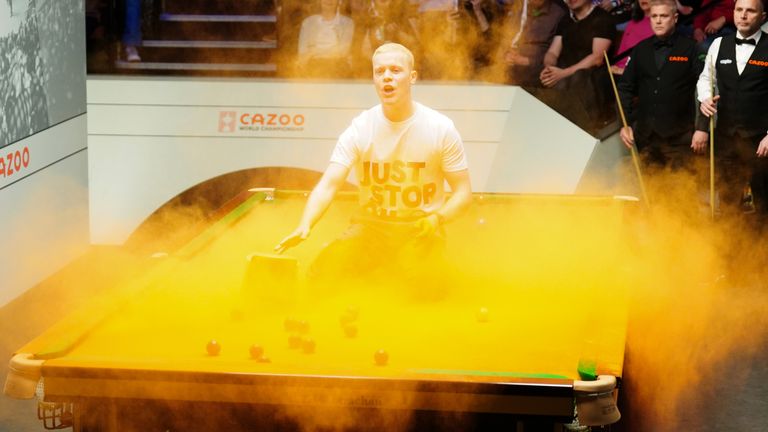 Cazoo World Snooker Championship 2023 - Day 3 - The Crucible
A Just Stop Oil protester jumps on the table during the match between Robert Milkins against Joe Perry during day three of the Cazoo World Snooker Championship at the Crucible Theatre, Sheffield. Picture date: Monday April 17, 2023.