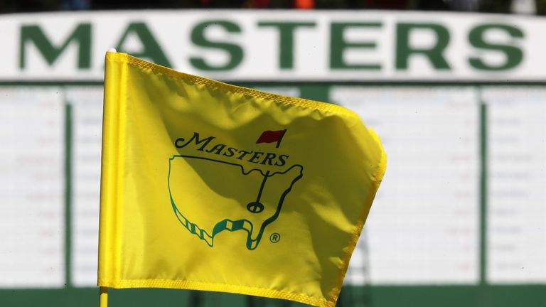 FILE - The Masters golf pin flag on the 9th green is seen with the scoreboard along the first fairway in the background at Augusta National Golf Club on Sunday, April 4, 2021, in Augusta, Ga. The Masters has no shortage of storylines at Augusta National. Tiger Woods returns after nearly two months. This will be only his third appearance against elite competition since last year's Masters. Rory McIlroy is in good form as he goes for the final leg of the career Grand Slam. And they share the stage with 18 players who most fans haven't see in more than nine months. (Curtis Compton/Atlanta Journal-Constitution via AP, File)