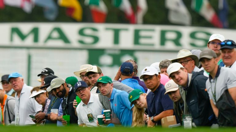 Patrons line the fairway on the first hole during the second round of the Masters golf tournament at Augusta National Golf Club on Friday, April 7, 2023, in Augusta, Ga. (AP Photo/Charlie Riedel)