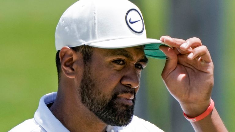 Tony Finau of United States adjusts his cap at the 9th green at the end the second round of the Mexico Open golf tournament in Puerto Vallarta, Mexico, Friday, April 28, 2023. (AP Photo/Moises Castillo)