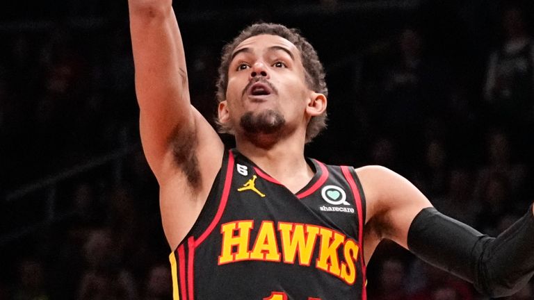 Atlanta Hawks guard Trae Young (11) shoots against Boston Celtics guard Derrick White (9) during the first half of Game 3 of a first-round NBA basketball playoff series, Friday, April 21, 2023, in Atlanta. (AP Photo/Brynn Anderson)