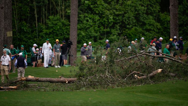 Authorities investigate the scene where trees fell on the 17th hole during the second round of the Masters golf tournament at Augusta National Golf Club on Friday, April 7, 2023, in Augusta, Ga. (AP Photo/Matt Slocum)