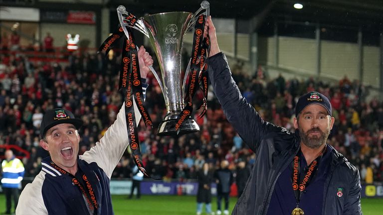 Wrexham co-owners Rob McElhenney and Ryan Reynolds celebrate with the National League trophy