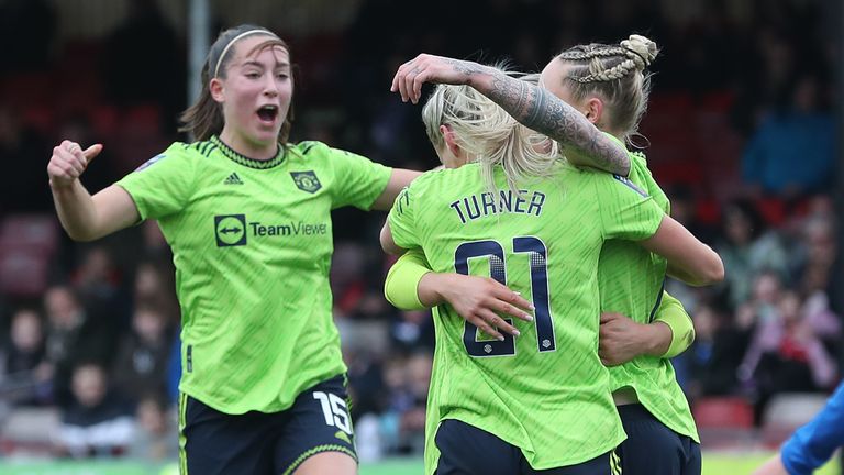 Manchester United players mob goalscorer Leah Galton after taking a 1-0 lead against Brighton