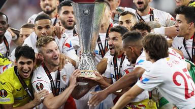 Sevilla's Ivan Rakitic and Jesus Navas lift the Europa League trophy