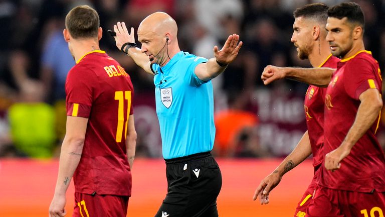 Referee Anthony Taylor signals no penalty for Sevilla after checking the VAR during the Europa League final