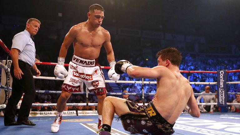 Michael Conlan (R) is floored by Luis Alberto Lopez in their IBF featherweight title fight in Belfast (PA Images)