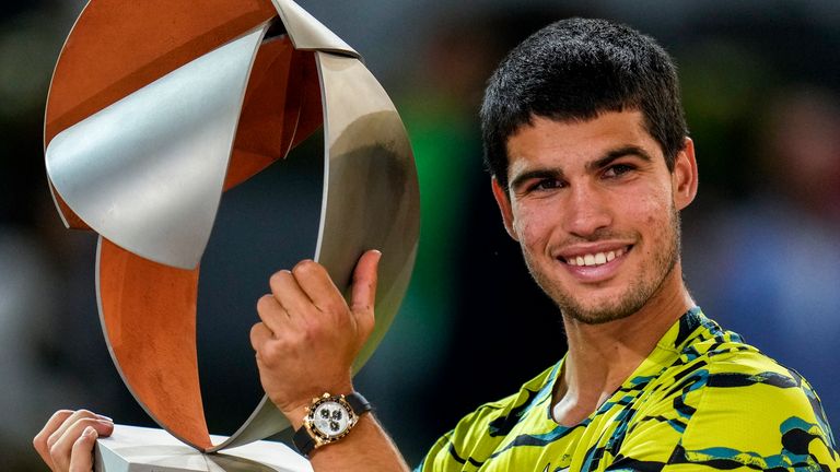 Carlos Alcaraz, of Spain, holds the winner's trophy after defeating Jan-Lennard Struff, of Germany, in the men's final at the Madrid Open 