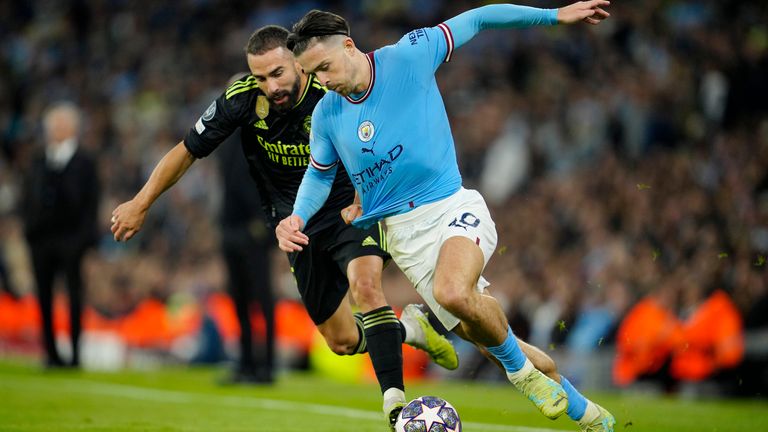 Real Madrid's Dani Carvajal vies for the ball with Manchester City's Jack Grealish, right, during the Champions League semifinal second leg soccer match between Manchester City and Real Madrid at Etihad stadium in Manchester, England, Wednesday, May 17, 2023. (AP Photo/Jon Super)