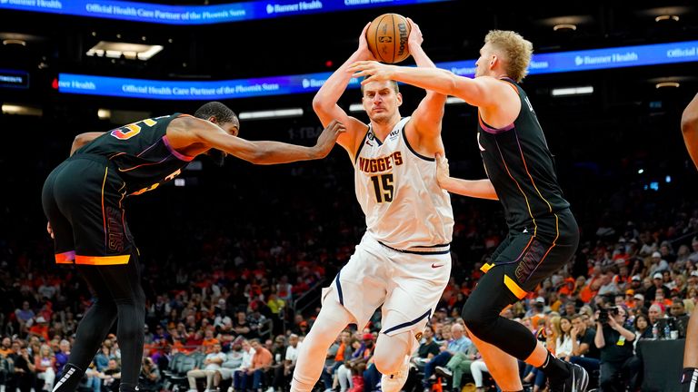 Denver Nuggets center Nikola Jokic drives past Phoenix Suns forward Kevin Durant and center Jock Landale