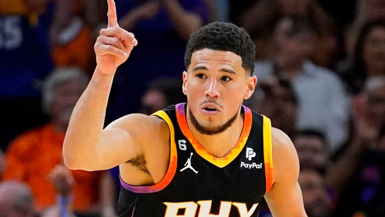 Phoenix Suns guard Devin Booker (1) celebrates a three pointer against the Denver Nuggets during the second half of Game 3 of an NBA basketball Western Conference semifinal game, Friday, May 5, 2023, in Phoenix. The Suns defeated the Nuggets 121-114. (AP Photo/Matt York)