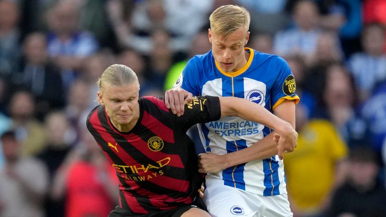 Brighton's Jan Paul van Hecke, right, challenges Manchester City's Erling Haaland 