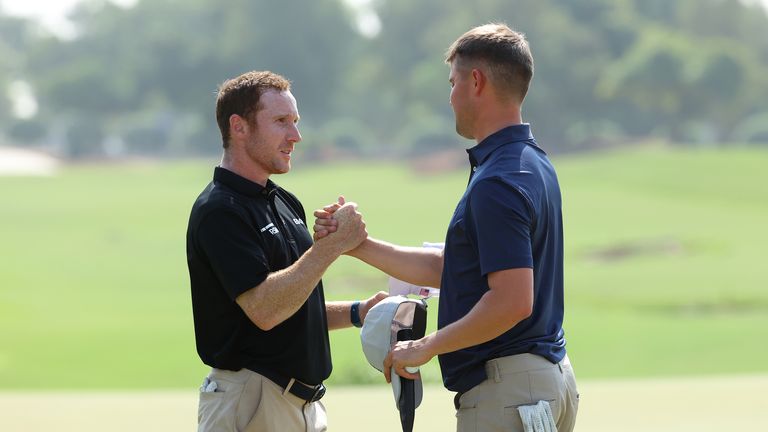 Chris Biggins (L) of United States and Kipp Popert of England shake hands following play at the 18th green during the final round of the Edga Dubai Final, part of The DP World Tour Championship at Jumeirah Golf Estates on November 20, 2021 in Dubai, United Arab Emirates. (Photo by Andrew Redington/Getty Images)