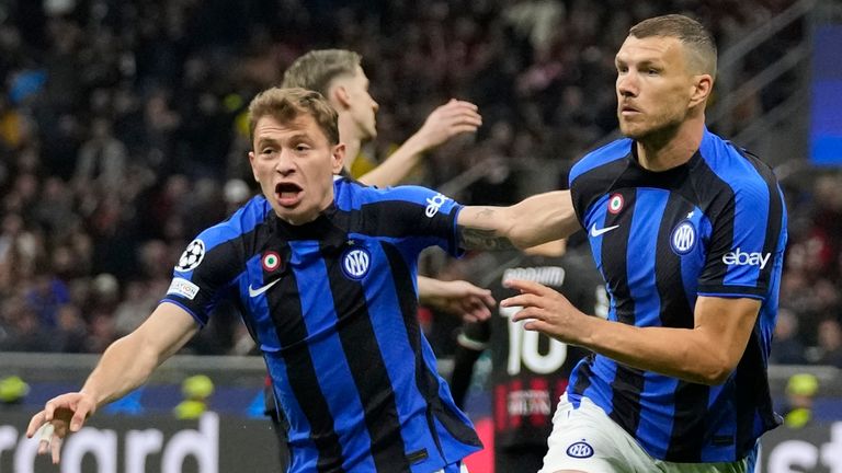 Inter Milan's Edin Dzeko, right, celebrates after scoring his side's opening goal during the Champions League semifinal first leg soccer match between AC Milan and Inter Milan at the San Siro stadium in Milan, Italy, Wednesday, May 10, 2023. (AP Photo/Antonio Calanni)