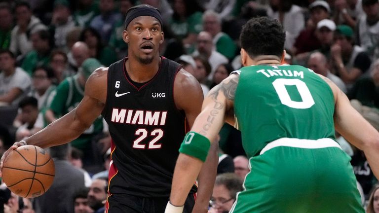Miami Heat forward Jimmy Butler, left, dribbles as Boston Celtics forward Jayson Tatum defends during the second half in Game 7 of the NBA basketball Eastern Conference finals Monday, May 29, 2023, in Boston. (AP Photo/Charles Krupa )
