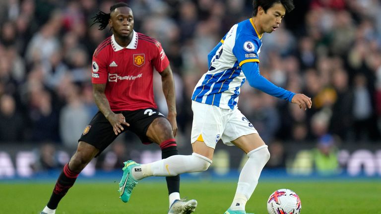 Brighton's Kaoru Mitoma, right, challenges for the ball with Manchester United's Aaron Wan-Bissaka during the English Premier League soccer match between Brighton and Hove Albion and Manchester United at the AMEX stadium in Brighton, England, Thursday, May 4, 2023. (AP Photo/Kirsty Wigglesworth)