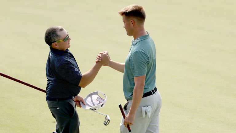 Kurtis Barkley of Canada and Kipp Popert of England shake hands after their round on the 18th green during the G4D Tour Series Finale @ DP World Tour Championship on the 18th green as part of the Day Three of the DP World Tour Championship on the Earth Course at Jumeirah Golf Estates on November 19, 2022 in Dubai, United Arab Emirates.