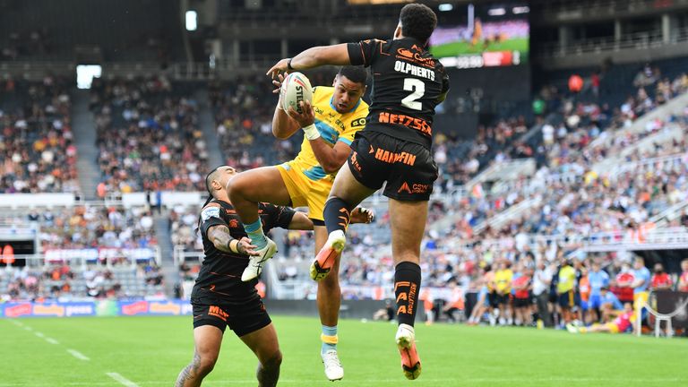 Picture by Will Palmer/SWpix.com - 09/07/2022 - Rugby League - Betfred Super League Magic Weekend - Leeds Rhinos v Castleford Tigers - St. James' Park, Newcastle, England - David Fusitu'a of Leeds Rhinos challenges Derrell Olpherts of Castleford Tigers for the ball