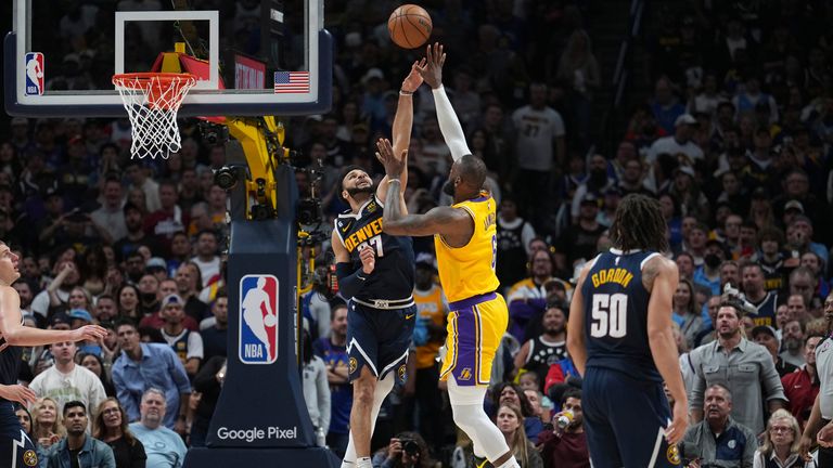 Los Angeles Lakers forward LeBron James shoots over Denver Nuggets guard Jamal Murray
