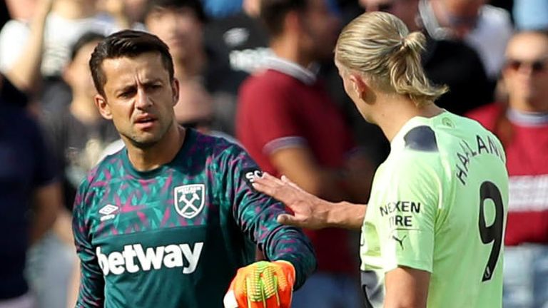 West Ham United goalkeeper Lukasz Fabianski (left) speaks with Manchester City's Erling Haaland (right) as he leaves the field to be replaced by goalkeeper Alphonse Areola (not pictured) after picking up an injury during the Premier League match at the London Stadium.  Picture date: Sunday August 7, 2022.
