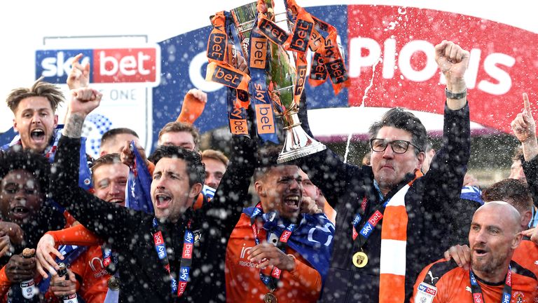Luton Town&#39;s Alan Sheedhan (eft) and manager Mick Harford (centre) and players celebrate with the Sky Bet League Two Trophy after the Sky Bet League One match at Kenilworth Road, Luton. PRESS ASSOCIATION Photo. Picture date: Saturday May 4, 2019. See PA story SOCCER Luton. Photo credit should read: Joe Giddens/PA Wire. RESTRICTIONS: EDITORIAL USE ONLY No use with unauthorised audio, video, data, fixture lists, club/league logos or "live" services. Online in-match use limited to 120 images, no video emulation. No use in betting, games or single club/league/player publications.