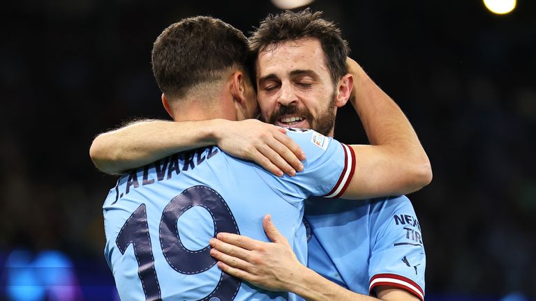 Manchester City's Julian Alvarez celebrates with Bernardo Silva after scoring a goal to make it 4-0 during the UEFA Champions League semi-final second leg between Manchester City FC and Real Madrid 