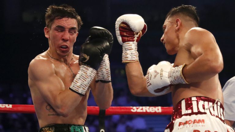 Luis Alberto Lopez (R) lands a punch in his IBF featherweight title defence against Michael Conlan in Belfast