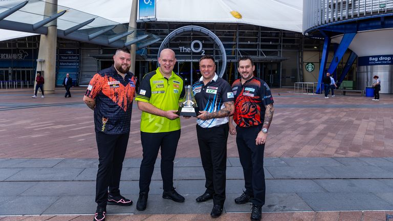 (Left to Right) Darts stars Michael Smith, Michael van Gerwen, Gerwyn Price and Jonny Clayton pose with the Cazoo Premier League trophy outside of The O2 ahead of the Cazoo Premier League Play-Offs on Thursday. Photo credit should read: Steven Paston/PDC