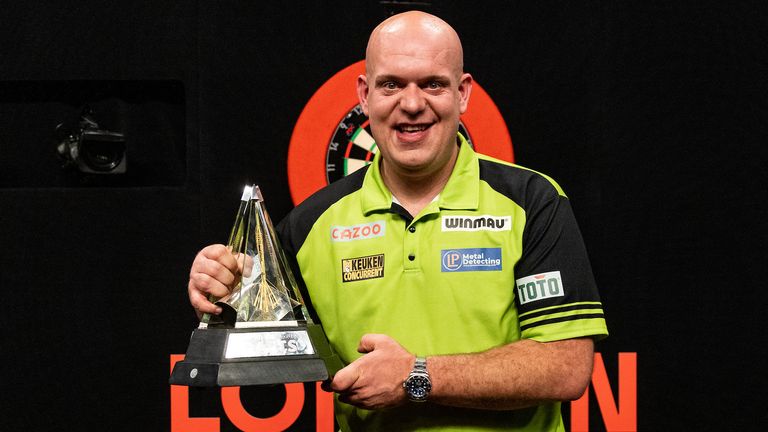 Michael Van Gerwen celebrates with the trophy after winning against Gerwyn Price in the final during the Cazoo Premier League Play-Offs. Photo credit should read: Steven Paston/PDC ..RESTRICTIONS: Use subject to restrictions. Editorial use only, no commercial use without prior consent from rights holder.