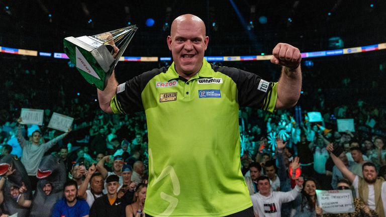 Michael Van Gerwen celebrates with the trophy after winning against Gerwyn Price in the final during the Cazoo Premier League Play-Offs. Photo credit should read: Steven Paston/PDC ..RESTRICTIONS: Use subject to restrictions. Editorial use only, no commercial use without prior consent from rights holder.