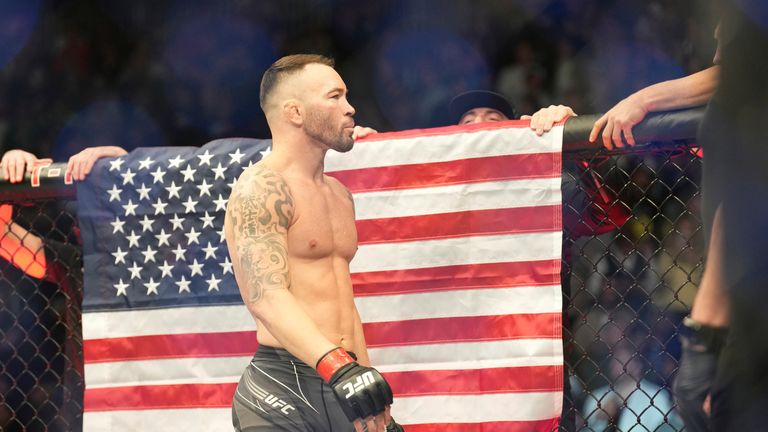Colby Covington in the octagon, with the American flag behind him. 