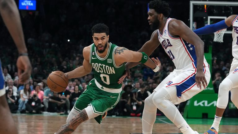 Boston Celtics forward Jayson Tatum (0) drives past Philadelphia 76ers center Joel Embiid (21) during the second half of Game 7 in the NBA basketball Eastern Conference semifinals playoff series, Sunday, May 14, 2023, in Boston.