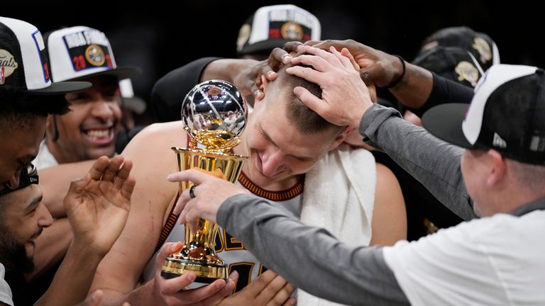 Denver Nuggets center Nikola Jokic is mobbed by teammates after accepting the series MVP trophy in Game 4 of the Western Conference Final series against the Los Angeles Lakers.