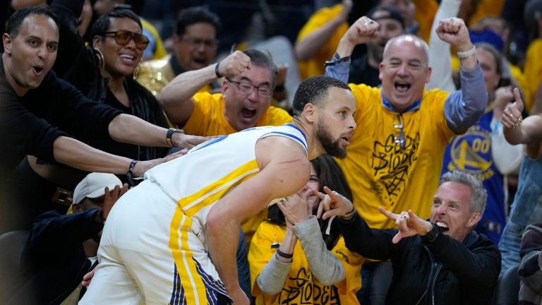 Fans cheer after Golden State Warriors guard Stephen Curry.